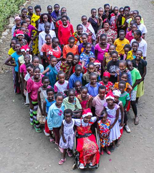 Children at Kenya Children's Homes forming a heart shape together