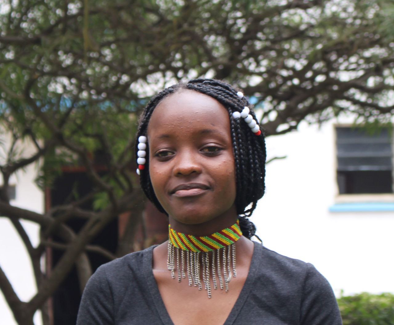 Young woman in traditional beaded necklace at KCH
