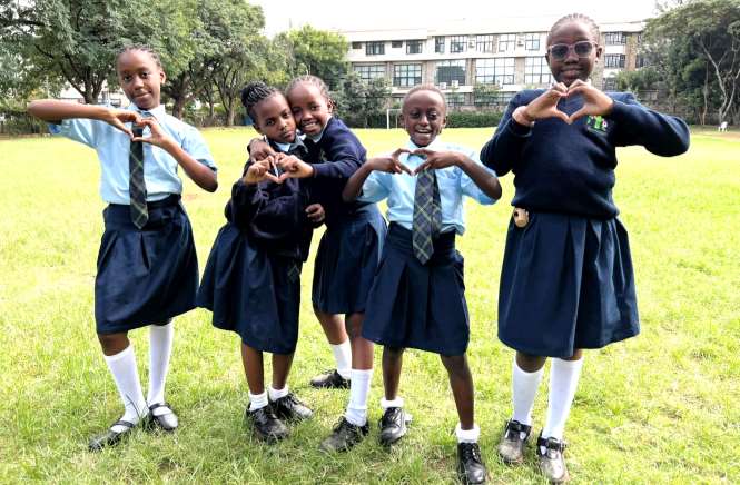Girls making heart signs